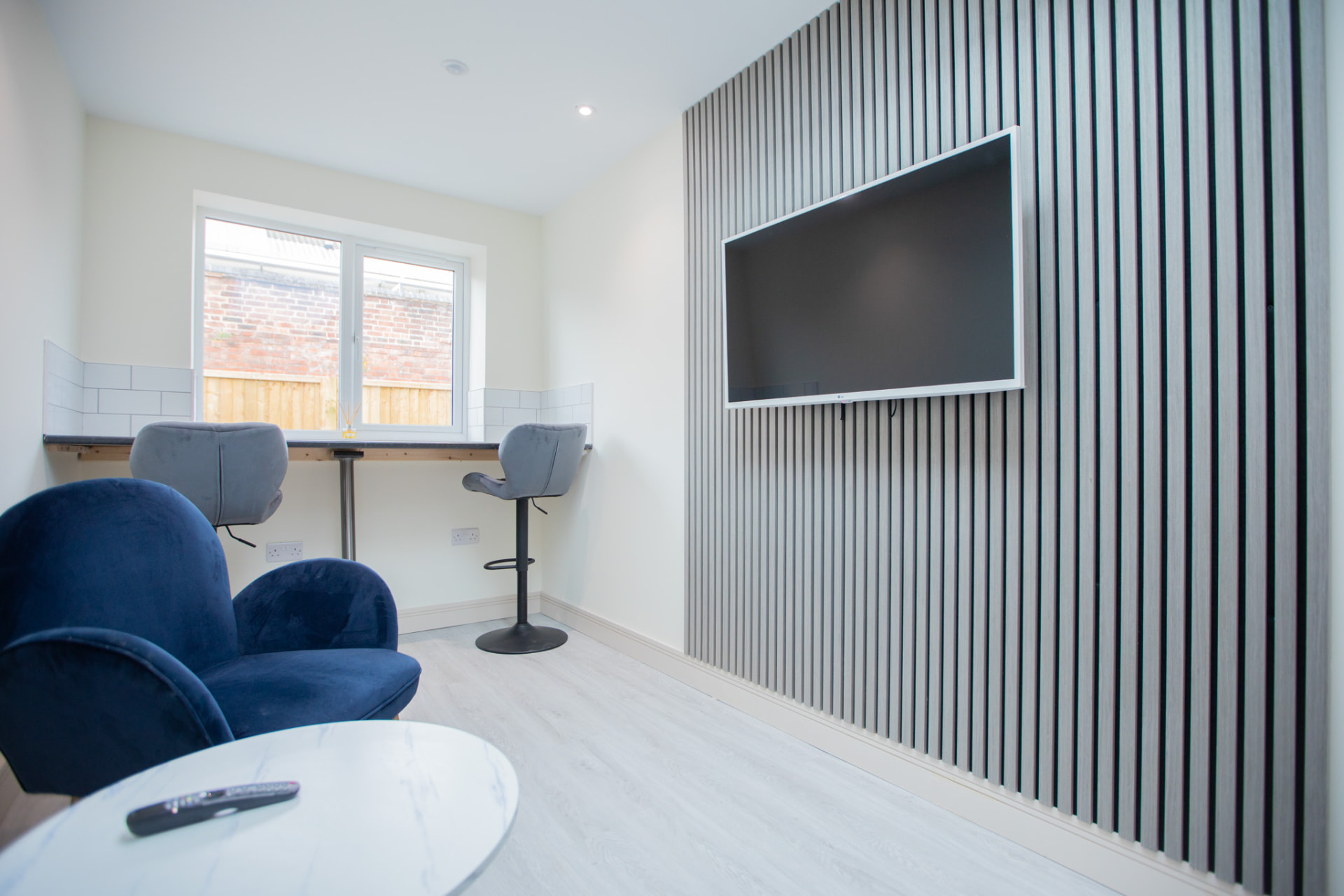 Barton Road after — communal lounge with slat wall